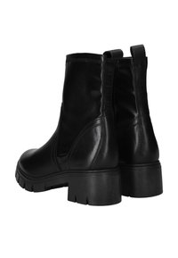 Zwarte leren enkellaarsjes met een ronde neus, elastische zijpanelen en een dikke, gestructureerde zool. Achterste trekhaak voor gemakkelijk aan- en uittrekken.