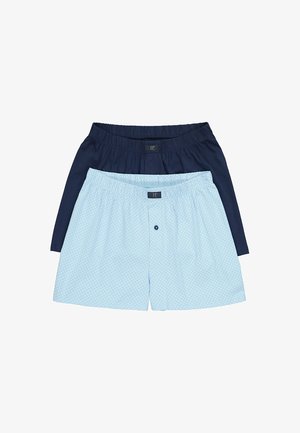 Deux paires de boxers pour hommes, un bleu foncé uni et un bleu clair avec un motif géométrique subtil, tous deux dotés d'une ceinture élastique et d'une braguette à boutons.