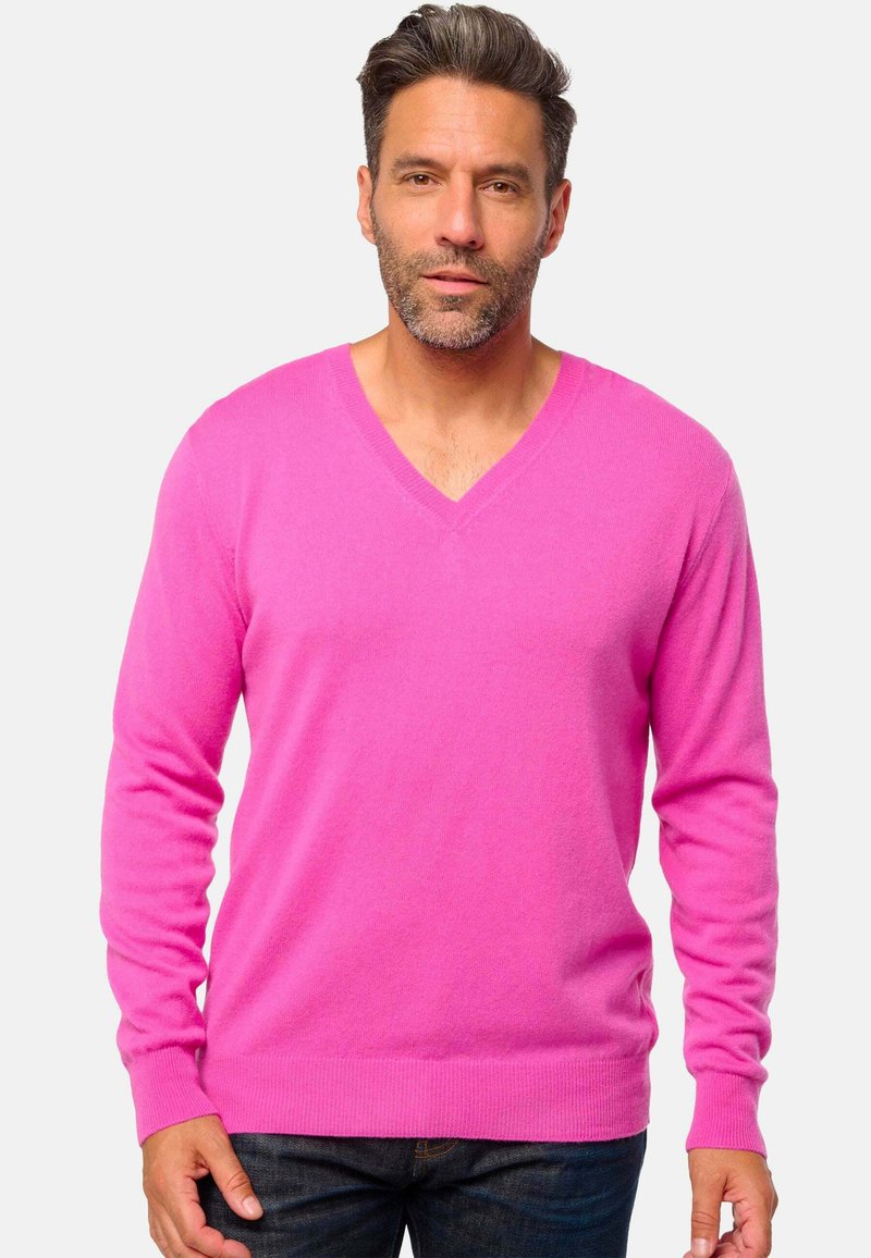 Pull rose en V en tissu doux ; manches longues avec poignets et ourlet côtelés ; texture lisse et minimalisme.