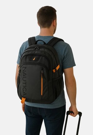 Black backpack with orange accents, multiple compartments, padded straps, and the word "NAUTICA" displayed prominently on the side.