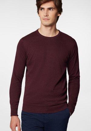 Burgundowa bluza z okrągłym dekoltem, z długimi rękawami, ściśle wykończonymi mankietami i dołem, wykonana z miękkiego, gładkiego materiału, o klasycznym wzornictwie.