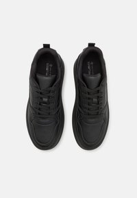 Black athletic shoes featuring a smooth leather upper, round toe, thick rubber sole, and textile accents with traditional lace-up design.