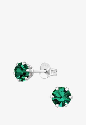 Boucles d'oreilles en cristal vert de forme ronde, montées en métal de couleur argentée. Elles comportent quatre griffes maintenant la pierre en toute sécurité.