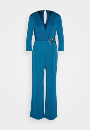 Turquoise jumpsuit met lange mouwen, wikkelontwerp, V-hals en gouden accenten op de taille. Glad, zacht materiaal. Wijdvallende fit.