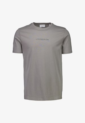 Vaaleanharmaa lyhythihainen T-paita, joka on valmistettu puuvillasta. Paidassa on pyöreä pääntie ja rinnassa tummaa harmaata tekstiä, jossa lukee "LINDBERGH".