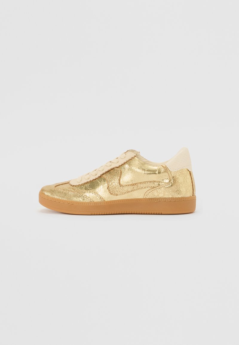 Gold sneaker with a cracked metallic finish, beige accents, textured tongue, and gum rubber sole. Low-top design with lace-up closure.