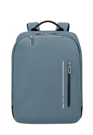 Gray backpack with a smooth texture, featuring a front zip pocket, a top handle, and adjustable shoulder straps. Minimalist design with a white stripe.