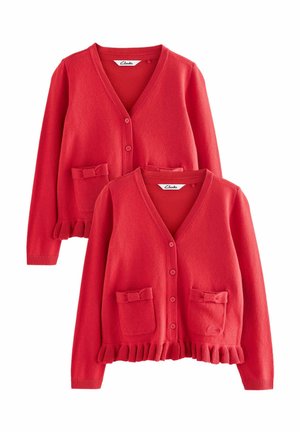 Gilet en laine rouge, décolleté en V, fermeture à boutons, avec deux poches ornées de nœuds. Ourlet froncé et finition texturée.