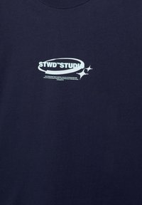 Navy blue cotton t-shirt featuring a white graphic print with text and star accents on the front, round neckline, and short sleeves.