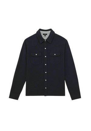Schwarze Langarmhemdjacke mit spitzem Kragen, Druckknopfverschluss und zwei aufgesetzten Fronttaschen mit Druckknöpfen.