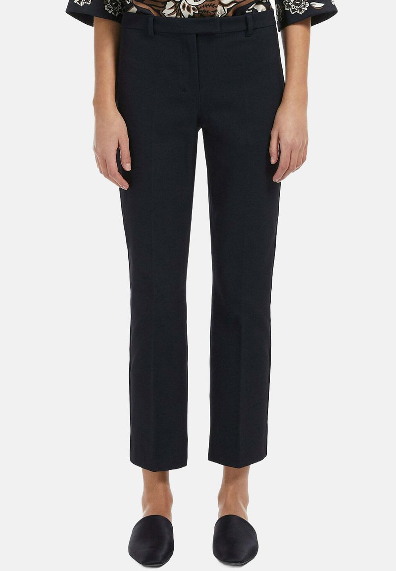 Pantalons noirs raccourcis avec une texture lisse, présentant une coupe ajustée et une taille mi-haute. Pas de motifs visibles ni de détails en métal.