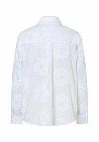 Witte blouse met bloemborduursel, lange mouwen en een kraag. Gelaagde bloemen met open stiksels over de achterkant.