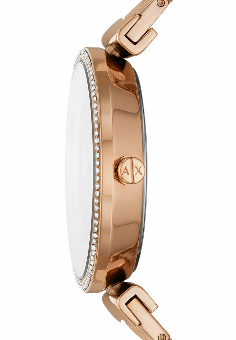 Runde Uhr mit einem Gehäuse aus Roségold. Verfügt über eine mit Kristallen besetzte Lünette und ein flaches Mineralglas. Metallverschluss für sicheren Halt.