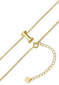 Zlato verižica z gladkim, cilindričnim poudarkom in okroglo zaponko z graviranim logotipom, ki prikazuje dizajn zank in sijočo teksturo.