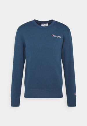 Laivastonsininen pitkähihainen pyöreäkauluksinen collegepaita, jossa Championin logo vasemmassa rinnassa ja pieni logo vasemmassa hihansuun mansetissa.