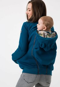 Felpa con zip blu dotata di cappuccio, con un motivo floreale interno e una tasca posteriore per trasportare un bambino, polsini e orlo a costine.