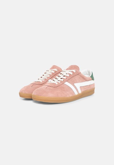 Paire de baskets basses en daim rose avec lacets blancs, bandes latérales blanches, semelles en gomme et languettes vertes au talon sur un fond clair.
