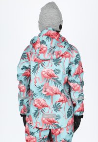 Waterproof jacket featuring a turquoise background with a pink flamingo and green foliage pattern. Includes a hood and adjustable cuffs.