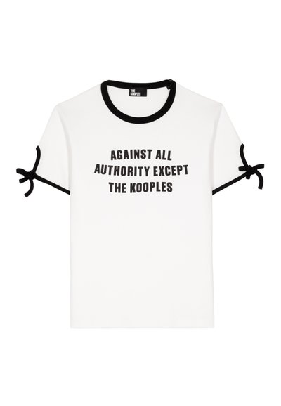Hvid t-shirt med sort tekst der læser "IMOD AL AUTORITET, UNDTAGEN KOOPLES." Har sort kant omkring halsudskæringen og ærmerne.
