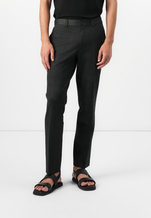 Dark grey tailored trousers made of a textured fabric, featuring a straight fit, a single button closure, and side pockets. Worn with black sandals.