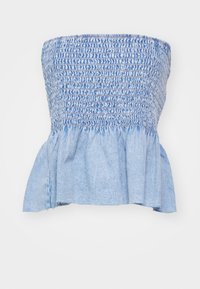 Lyseblå denim strapless topp med samlet smocket tekstur ved bysten og en bred peplum-fald. Myk stoff med minimal slitasje.