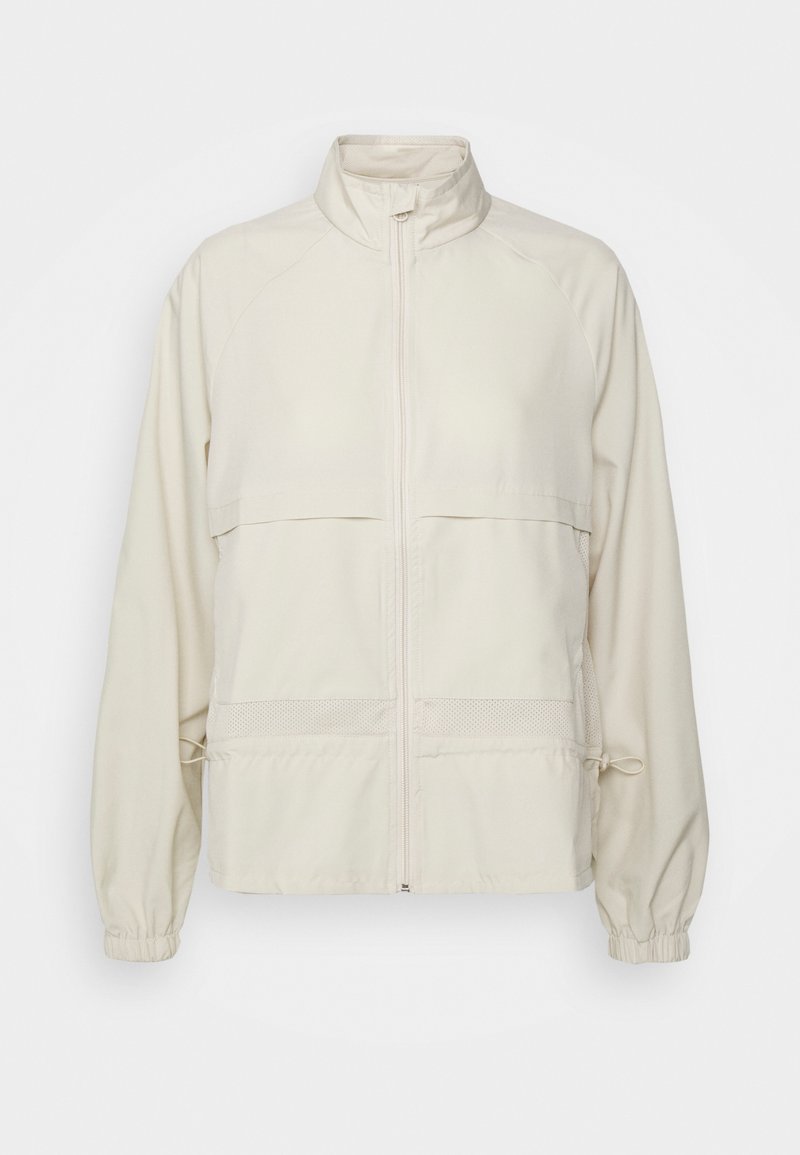 Světle béžová zipová bunda vyrobená z hladkého materiálu. Má stojáček, dvě náprsní kapsy, elastické manžety a nastavitelné stahování v pase.
