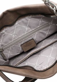 Brown leather handbag interior features a zipped pocket and grey lining with a dotted pattern. Zippered closure along the top edge.
