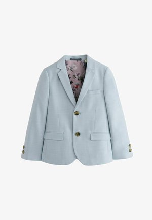 Svetlo modra blazerica iz teksturirane tkanine, z odprtim ovratnikom, dvema sprednjima žepoma in podlogo s cvetličnim vzorcem. Vidni so trije gumbi.