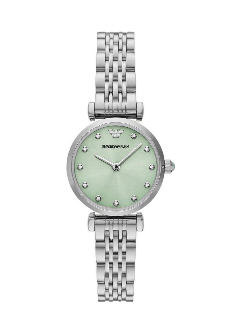 Stříbrné nerezové hodinky s oválným ciferníkem, mátově zeleným podkladem, hodinovými značkami připomínajícími diamanty a texturovaným náramkem.