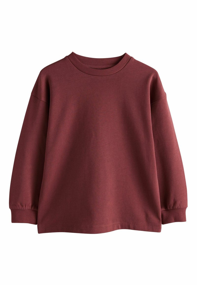 Burgundi värvi puuvillane dressipluus, millel on ümar kaelus, langenud õlad ja soonikkoes mansetid. Omab siledat tekstuuri ja mugavat lõiget.