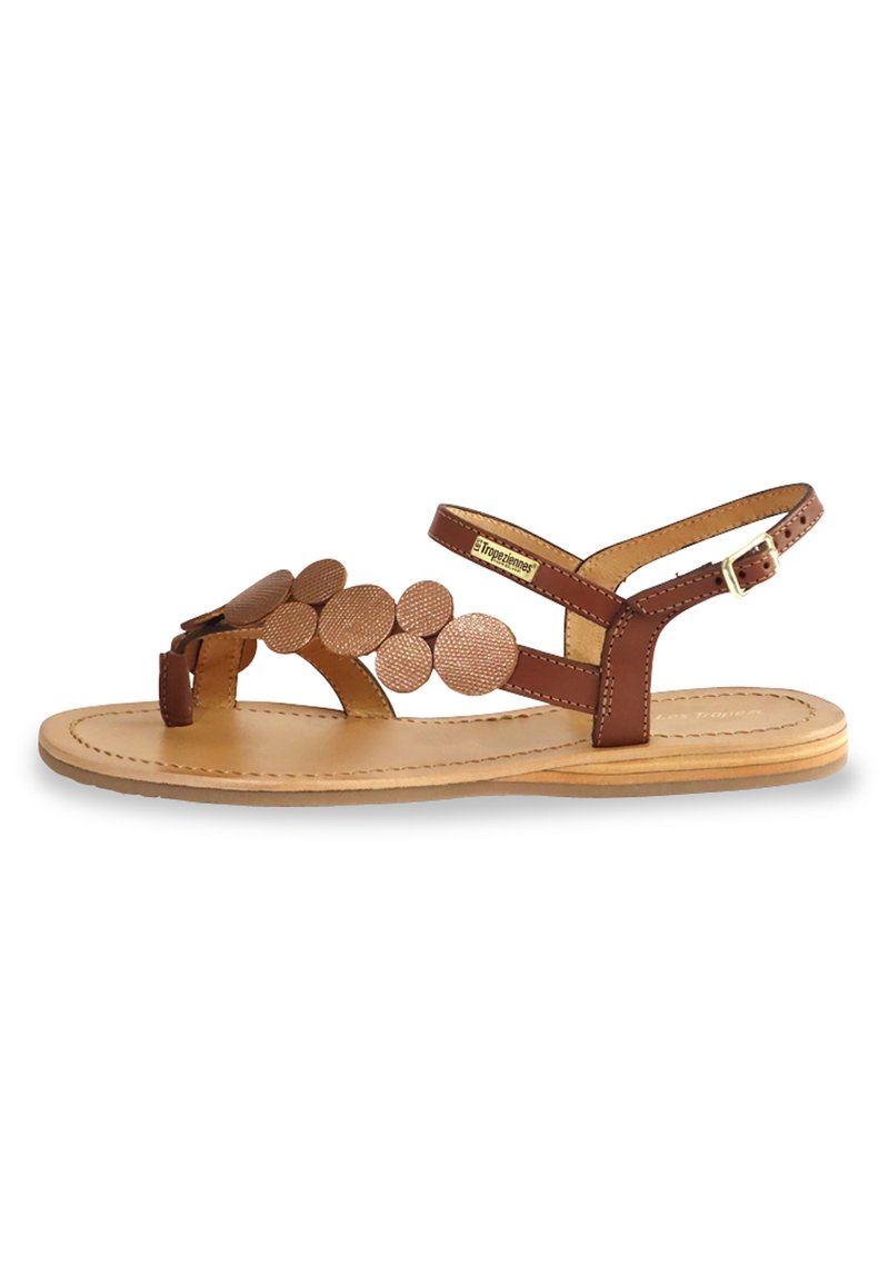 Brown leather sandals with circular accents, ankle strap, and flat sole. Features a layered design and natural beige insole.