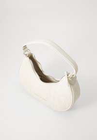 Cream-colored handbag with embossed logo design, curved shape, adjustable strap, and silver-tone zipper. Textured leather finish.