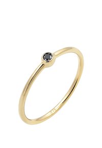Goldring mit einem glatten, dünnen Band und einem einzigen runden schwarzen Stein in der Mitte. Verfügt über eine polierte Oberfläche mit klaren Details.