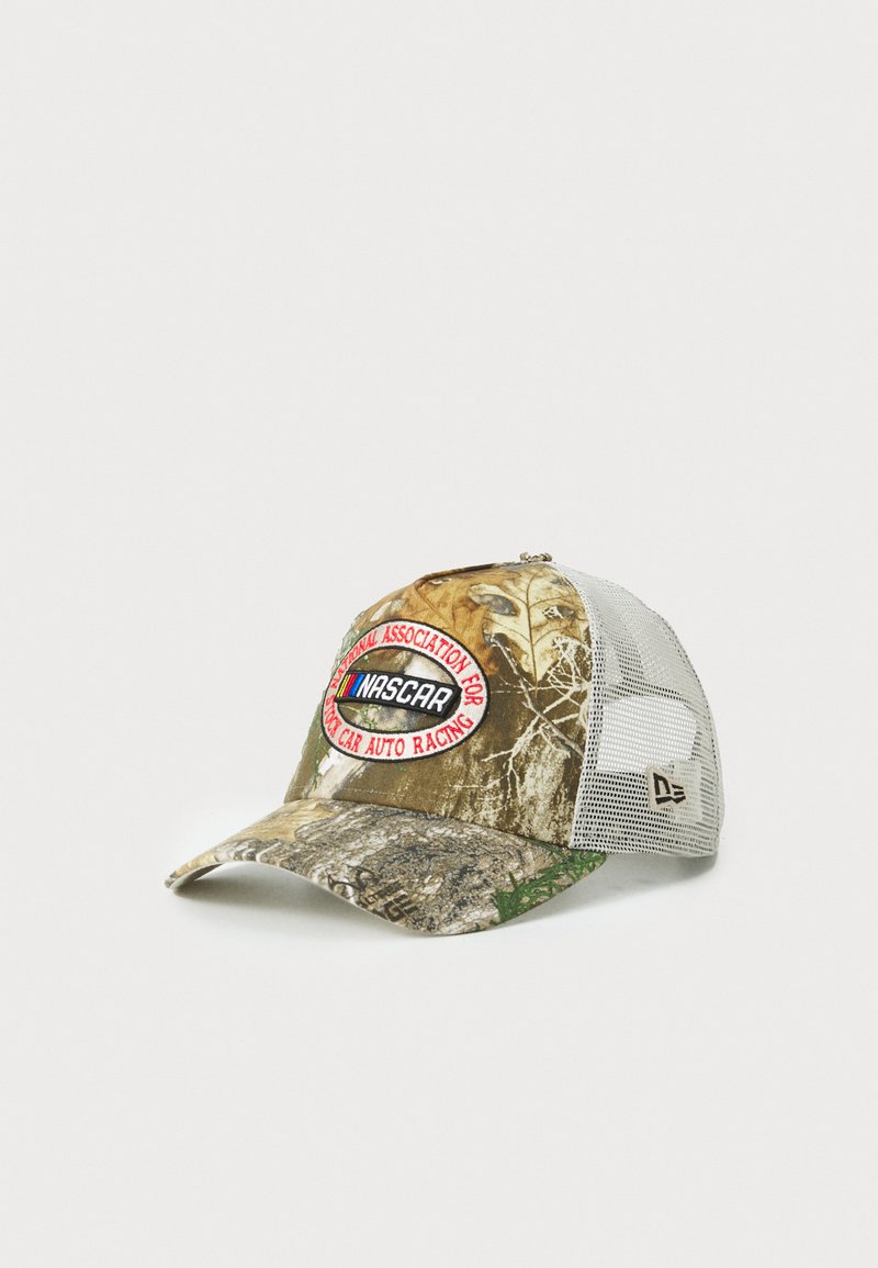 Camo cap with mesh back, featuring a round NASCAR logo patch in red and black. Colors include brown, green, and gray with natural patterns.