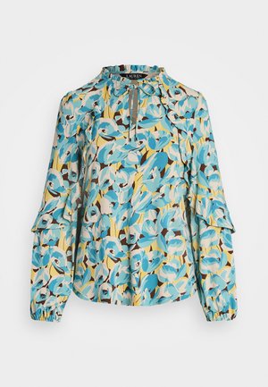 Bloes met bloemenpatroon in blauw, geel en bruin. Volante mouwen en geplooide halslijn. Gemaakt van lichtgewicht stof.