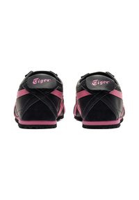 Black and pink athletic shoes with a smooth leather and suede finish. Features crosshatch stitching and diagonal pink accents. "Tiger" branding on the back.