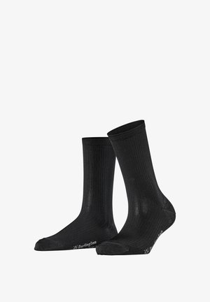 Paire de chaussettes montantes noires à côtes avec bouts renforcés et logo "Burlington" gris sur la semelle, présentées debout sur un fond blanc.