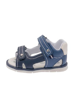 Sandalo azzurro e bianco per bambino piccolo con due cinturini regolabili in velcro e fodera interna imbottita, mostrato di profilo.