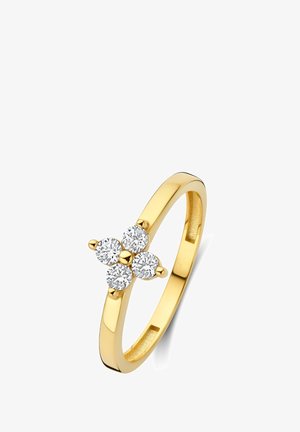 Bague en or ornée de quatre pierres rondes et translucides disposées en forme florale. Anneau lisse, finition polie et design élégant.