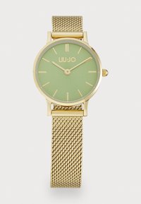 Goldfarbener Mesh-Armbanduhren mit einem runden Gehäuse, mattem grünen Zifferblatt, goldenen Stundenmarkierungen und einem goldenen Logo an der 12-Uhr-Position.
