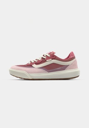Low-top sneakers in varying shades of pink, featuring a synthetic upper, textured details, a white midsole, and contrasting laces.