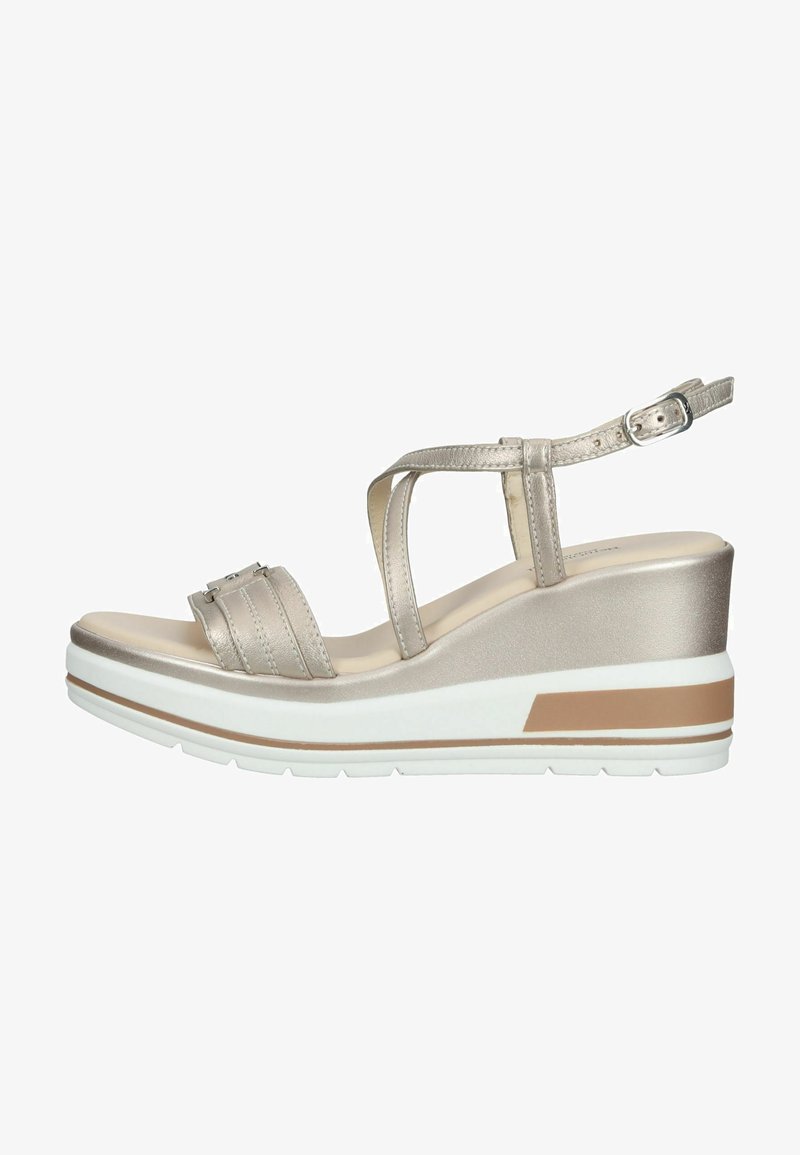 Wedge sandals with a shiny metallic finish. Features a wide strap and adjustable ankle strap. White outsole with a tan accent band.