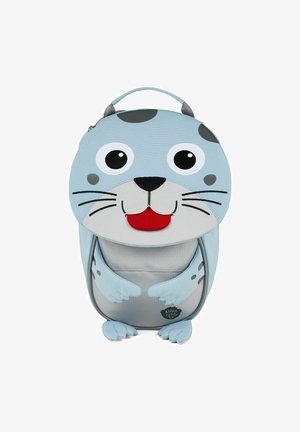 Light blue children's backpack shaped like a seal, featuring a round head with large eyes, a smiling mouth, and flipper-like straps.