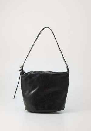 Black leather shoulder bag with a smooth texture, a zip closure, and a long, rounded handle. The bag has a slouchy, unstructured shape.