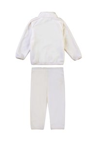 Tuta in pile bianco con colletto, maniche lunghe e pantaloni con vita elasticizzata. Tessuto morbido senza motivi o decorazioni visibili.