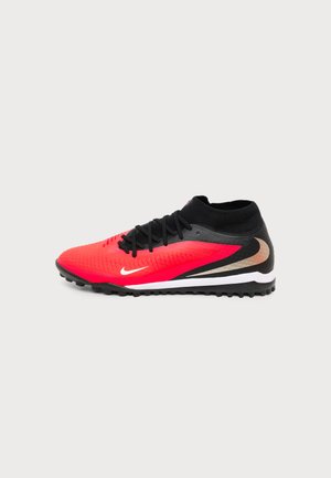 Vue latérale d'une chaussure de football Nike rouge et noire avec des lacets noirs et une semelle texturée sur fond blanc.