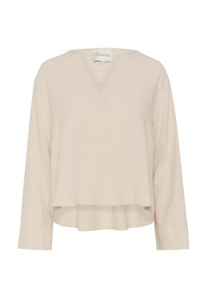 Top beige de manga larga con escote en V, de textura suave y corte corto. Cuenta con aberturas laterales en el dobladillo para facilitar el movimiento.