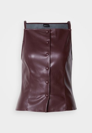 Burgundy sleeveless top in faux leather with a tailored fit. Features a front button closure and smooth, glossy texture.