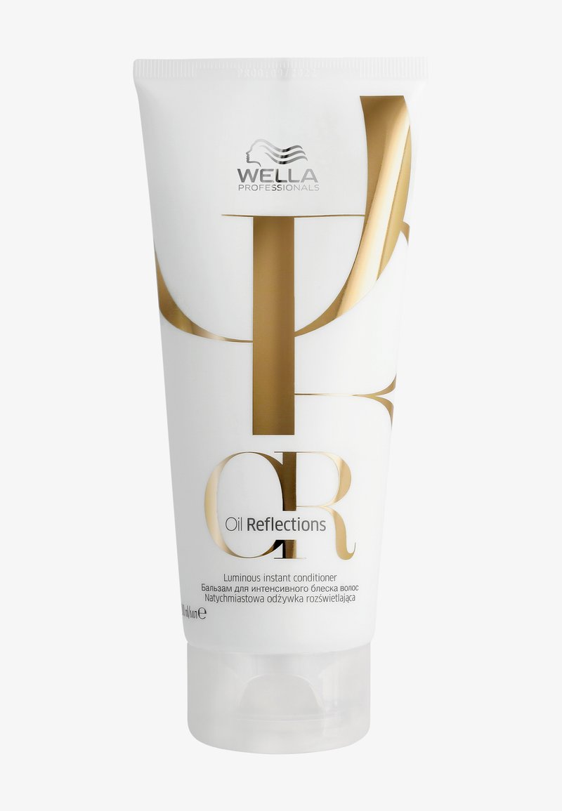 Wella Professionals Oil Reflections après-shampooing instantané lumineux dans un tube blanc avec lettrage doré et bouchon rabattable transparent.