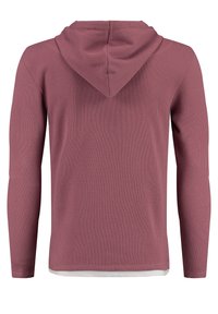Langärmliges, kapuzenförmiges Oberteil aus weichem, kastanienbraunem Rippstoff mit strukturierter Oberfläche, das einen weißen unteren Saum und ein standardmäßiges Passformdesign aufweist.